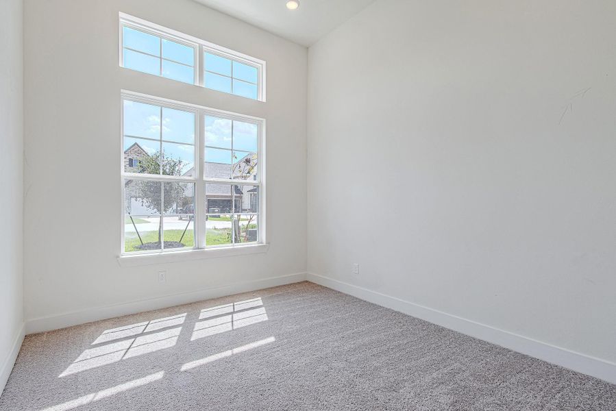 Secondary bedroom filled with natural light and neutral finishes