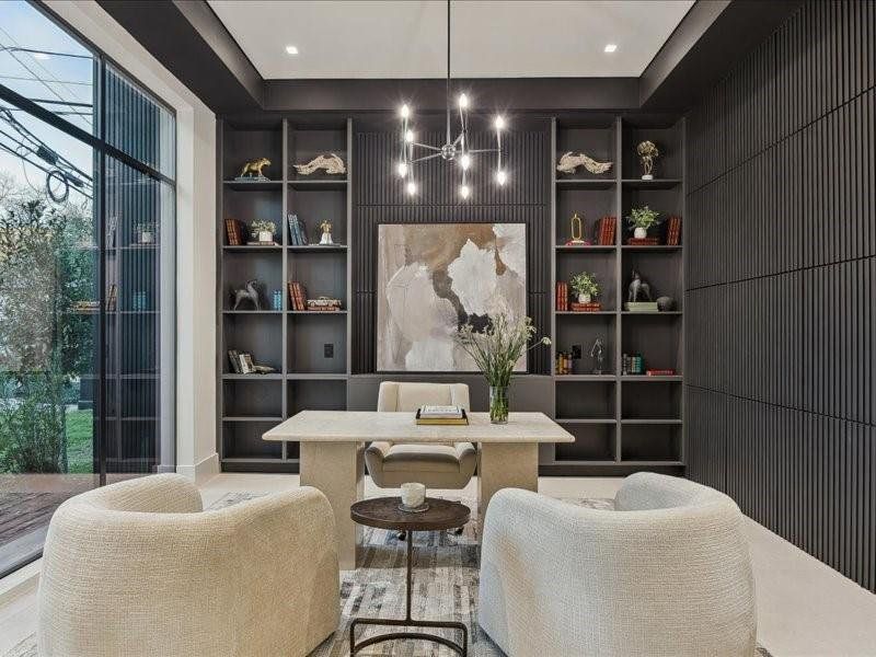 A stylish office with custom built-ins and an expansive window offers the perfect blend of productivity and relaxation.