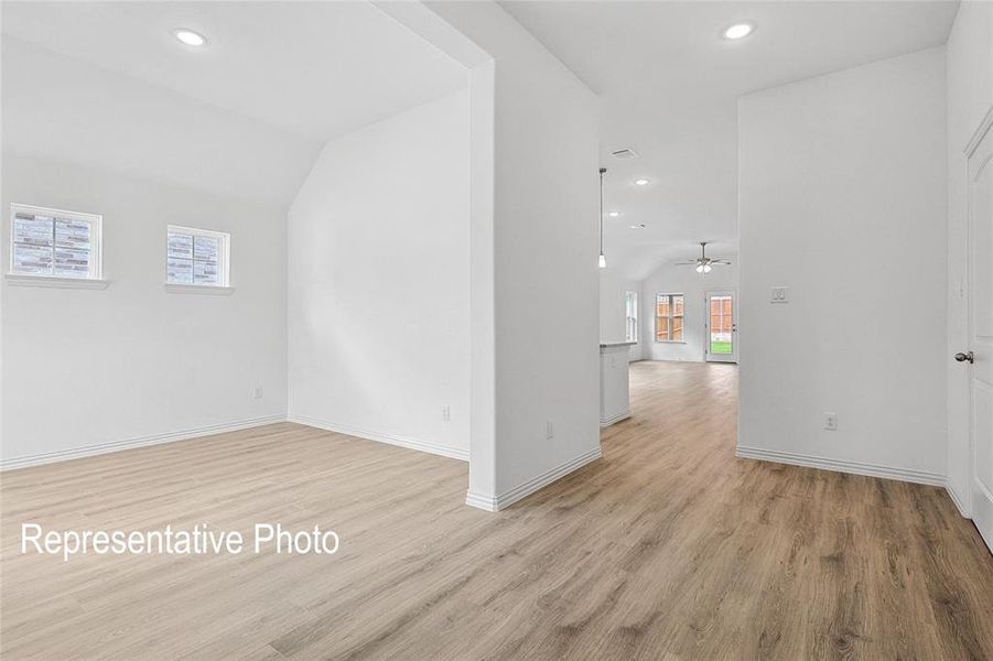 Spacious interior featuring wood-finish flooring, recessed lighting, and crisp white walls throughout