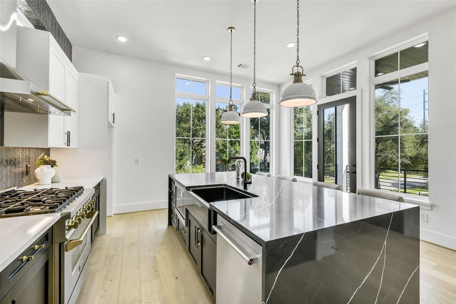 A stunning mix of style and performance, this kitchen features a dual-finish palette, under-cabinet lighting, pot filler, and energy-efficient windows. The island includes a microwave drawer, built-in storage, and quartz waterfall edges for durability and refined appeal. Every element—from the premium hardware to the herringbone accent wall—reflects custom builder craftsmanship. A stunning mix of style and performance, this kitchen features a dual-finish palette, under-cabinet lighting, pot filler, and energy-efficient windows. The island includes a microwave drawer, built-in storage, and quartz waterfall edges for durability and refined appeal. Every element—from the premium hardware to the herringbone accent wall—reflects custom builder craftsmanship.