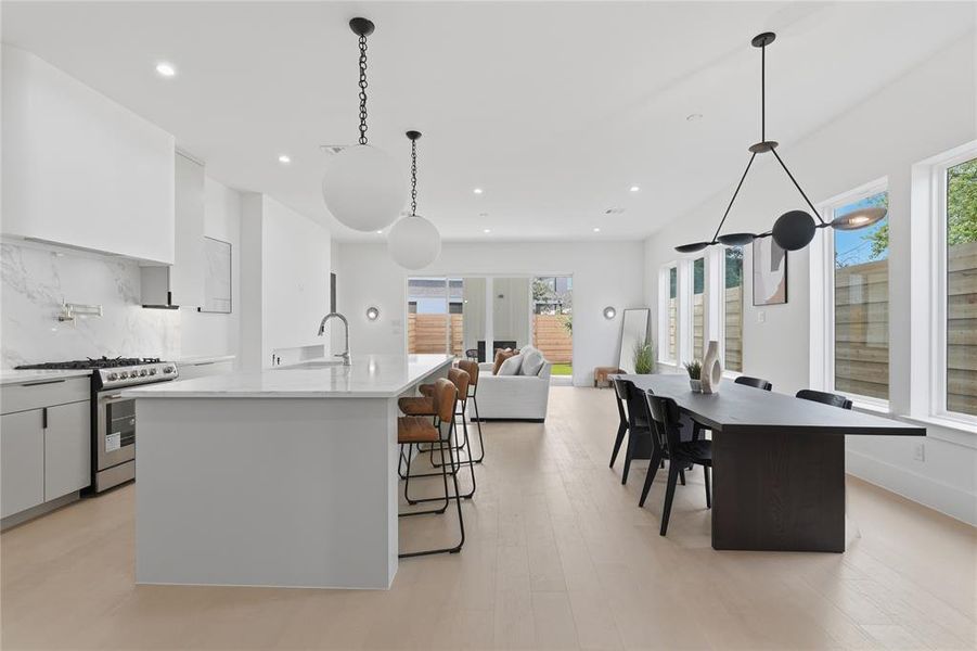 Modern open-concept living space with light wood-finish flooring