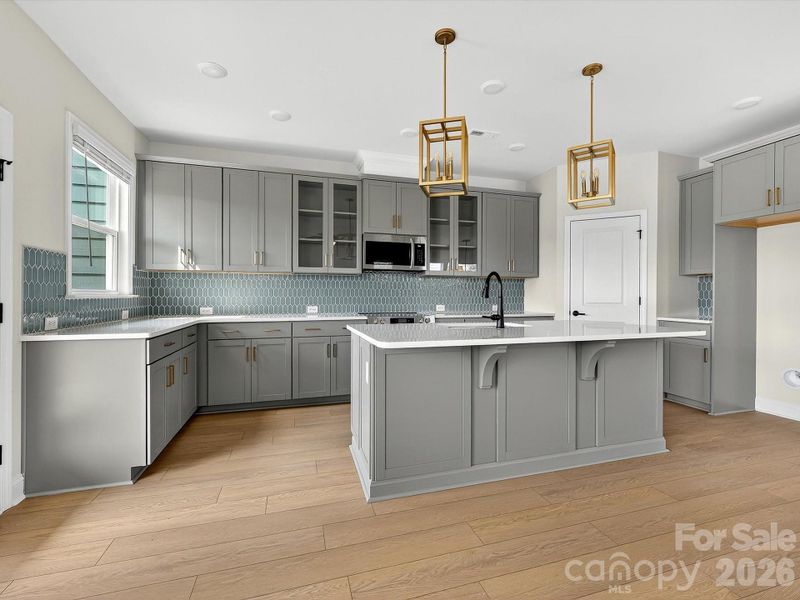 42" cabinets with soft close doors and drawers, quartz countertops, tile backsplash. Frigidaire gallery appliances. Microwave is exhaust vented to the outside. Large pantry with solid shelving