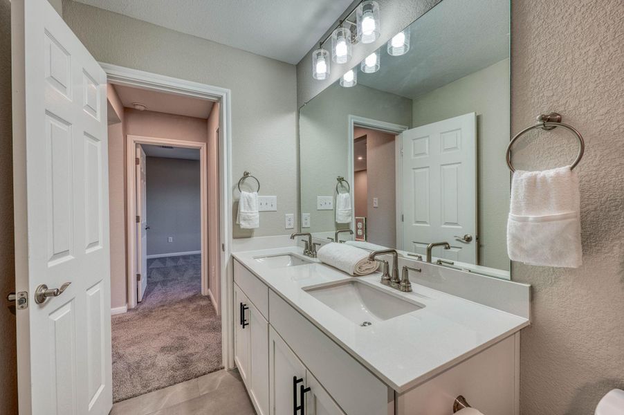Clean lines and a spacious dual vanity define this modern, light-filled bathroom design. Clean lines and a spacious dual vanity define this modern, light-filled bathroom design.