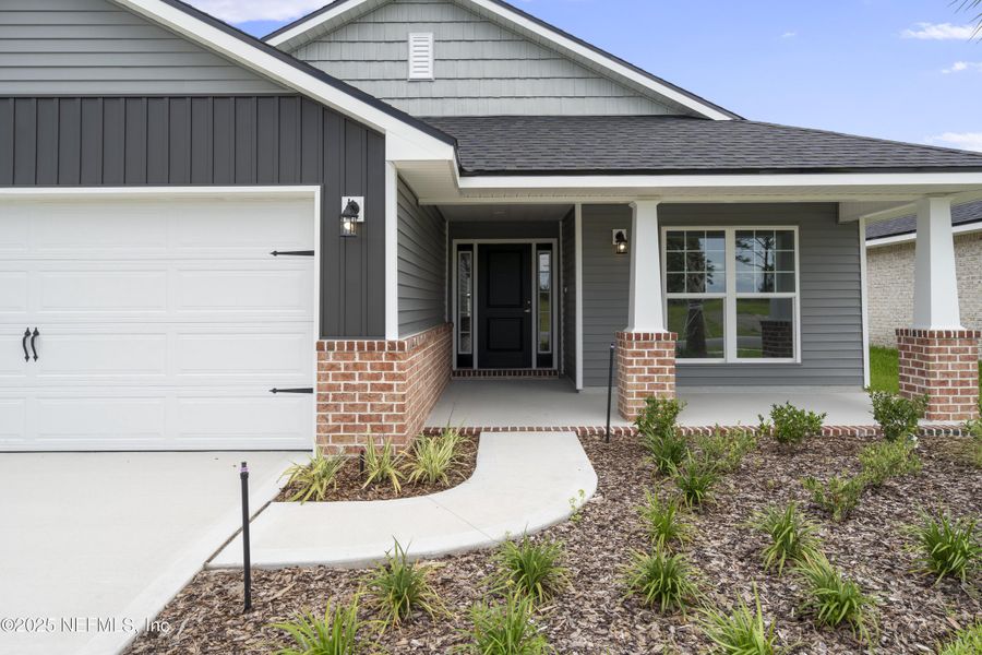 Front exterior of a new home in Shadow Crest at Rolling Hills, Green Cove Springs, FL, highlighting curb appeal (Image 2).