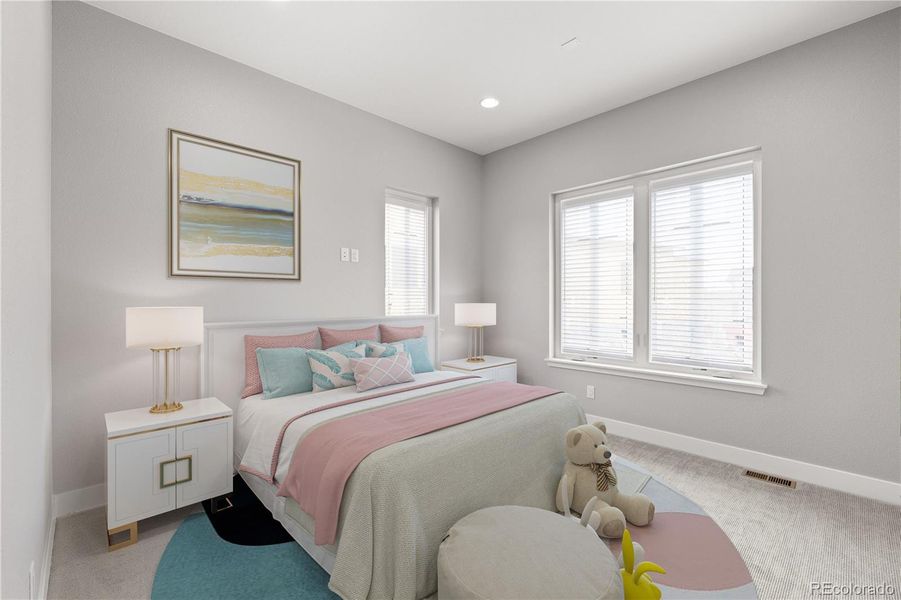 Main level guest bedroom with en suite bathroom and walk-in closet. *This photo has been virtually staged.