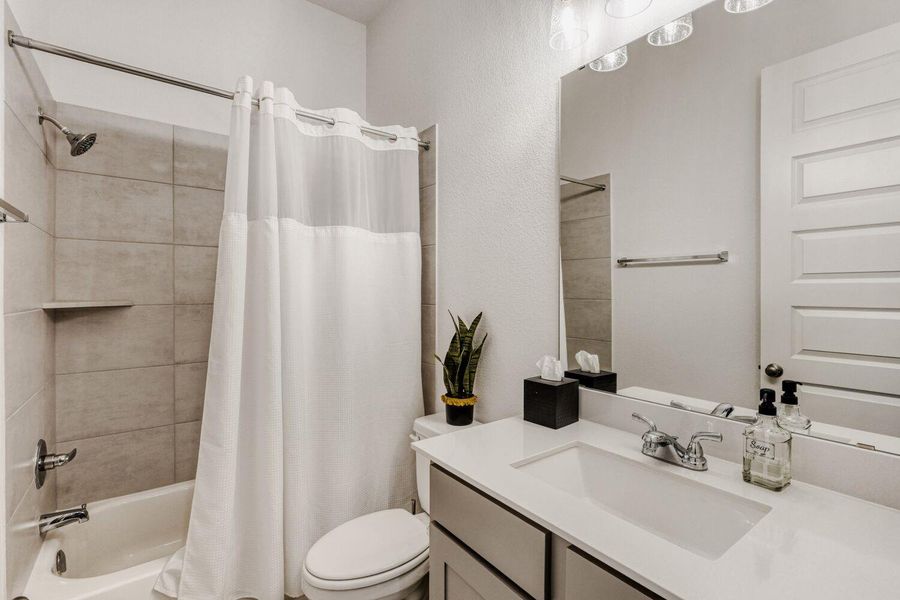 Bathroom with vanity and shower / bath combination with curtain