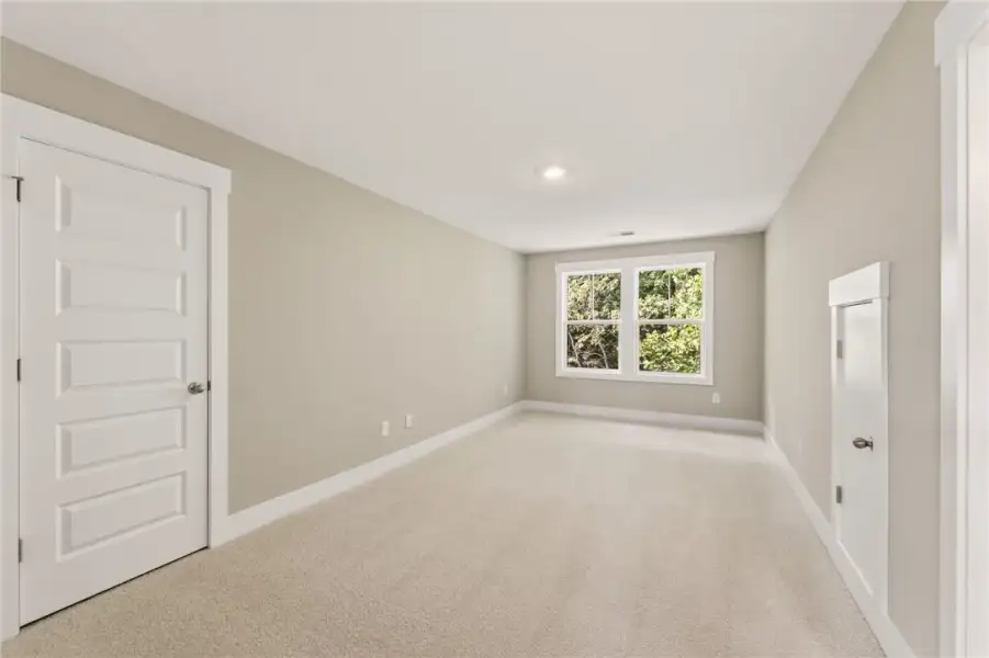 A spacious, naturally illuminated room features pl A spacious, naturally illuminated room features pl