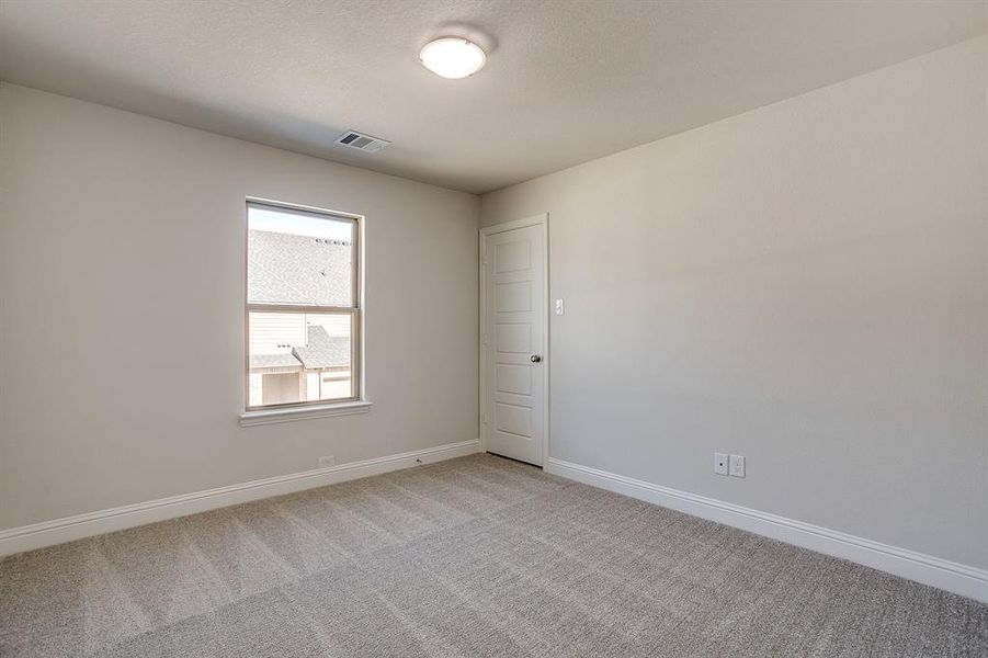 Unfurnished room with light carpet and baseboards