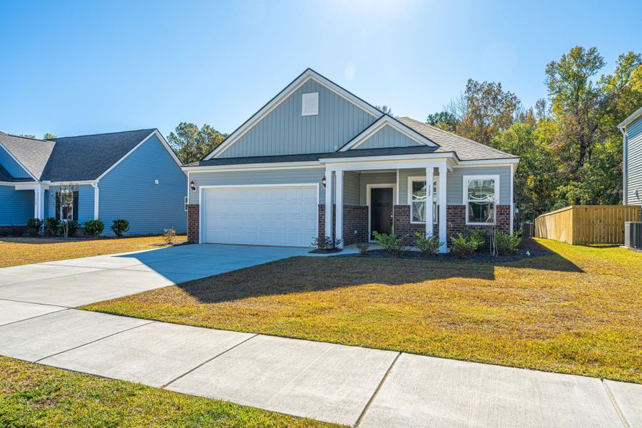 Front exterior of a new home in Cedar Glen Preserve, Huger, SC, highlighting curb appeal (Image 1).