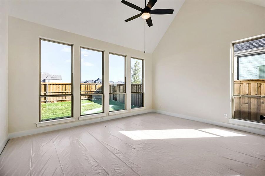 Empty room featuring vaulted ceiling and a ceiling fan Empty room featuring vaulted ceiling and a ceiling fan