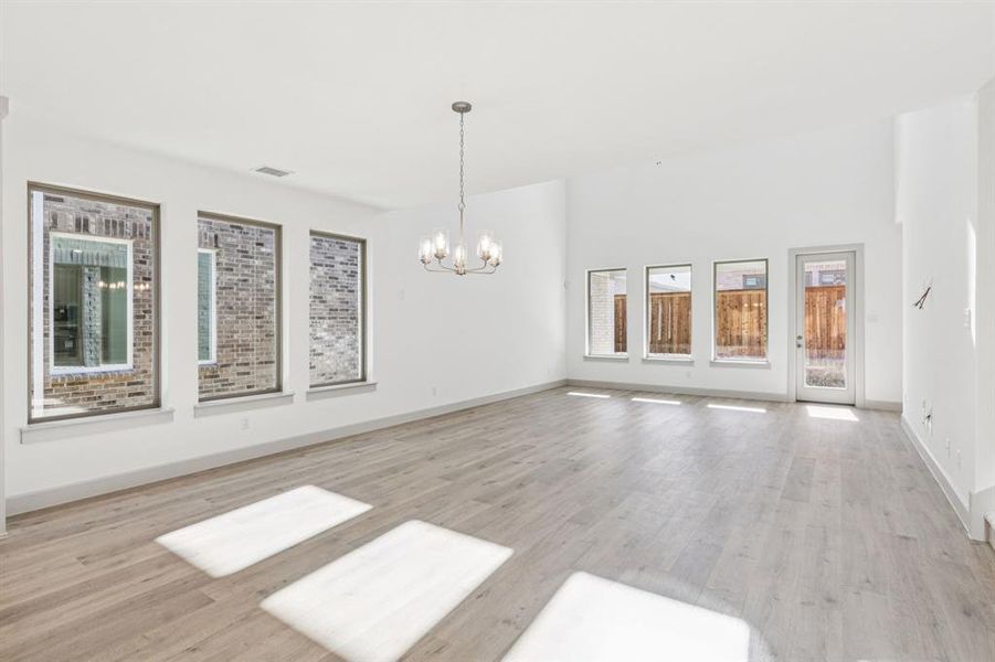 Featuring a view to the outdoors through a wall of windows, this dining room is the perfect setting for lively dinner parties or cozy family meals! Featuring a view to the outdoors through a wall of windows, this dining room is the perfect setting for lively dinner parties or cozy family meals!