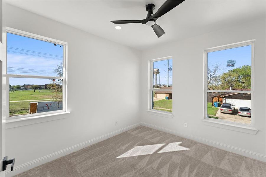 Unfurnished room featuring a ceiling fan, carpet floors, and recessed lighting