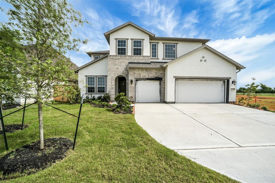 Front exterior of a new home in Del Bello Lakes 60', Manvel, TX, highlighting curb appeal (Image 1). Front exterior of a new home in Del Bello Lakes 60', Manvel, TX, highlighting curb appeal (Image 1).