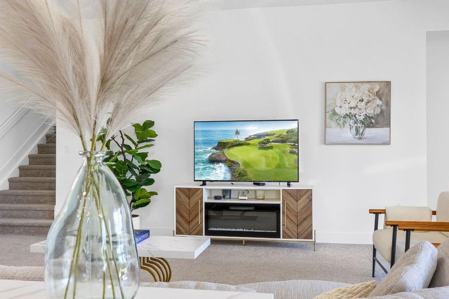 Living area featuring carpet and stairs