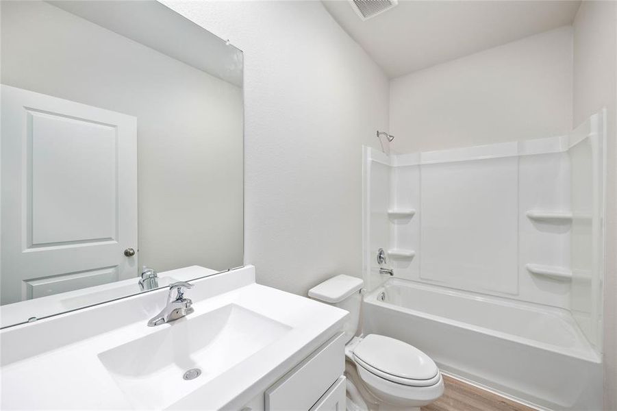 The secondary bathroom, located centrally in the hallway of the home.