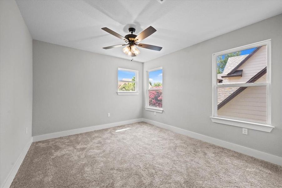 Empty room featuring carpet and ceiling fan