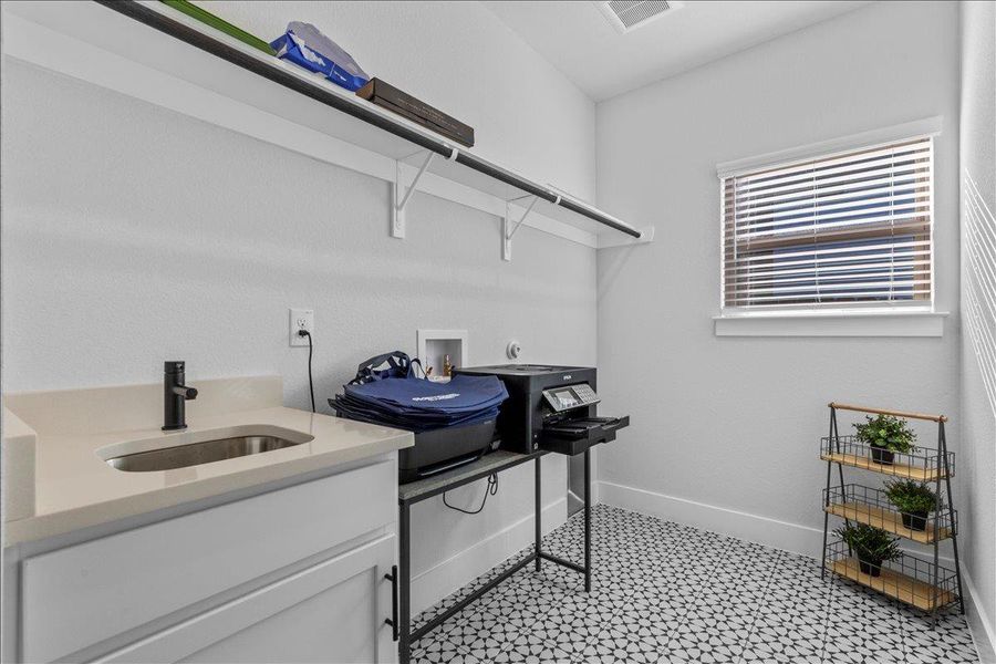 Washroom featuring hookup for a washing machine and cabinet space
