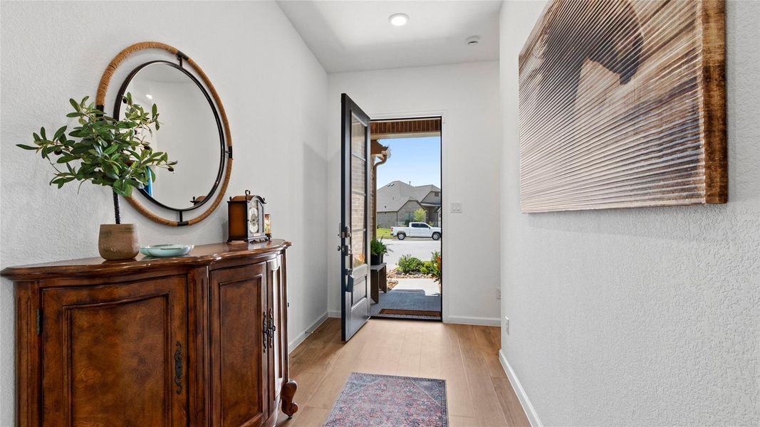 A stylish, welcoming entryway opens to a thoughtfully designed hallway with convenient access to the secondary bedrooms and bathroom, enhancing the home’s desirable split-bedroom floor plan. A stylish, welcoming entryway opens to a thoughtfully designed hallway with convenient access to the secondary bedrooms and bathroom, enhancing the home’s desirable split-bedroom floor plan.