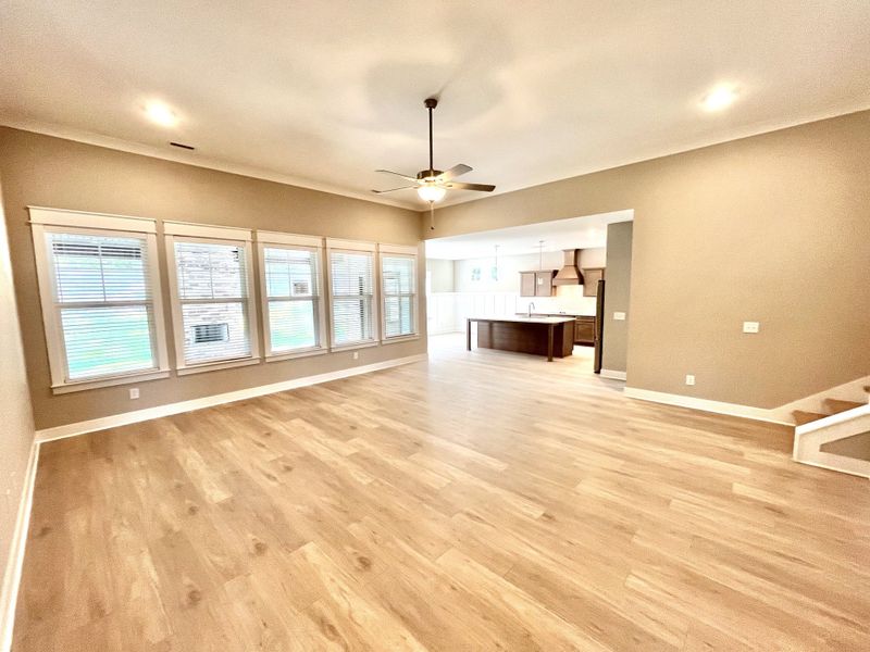 Love this large great room with all of those windows and high ceilings!