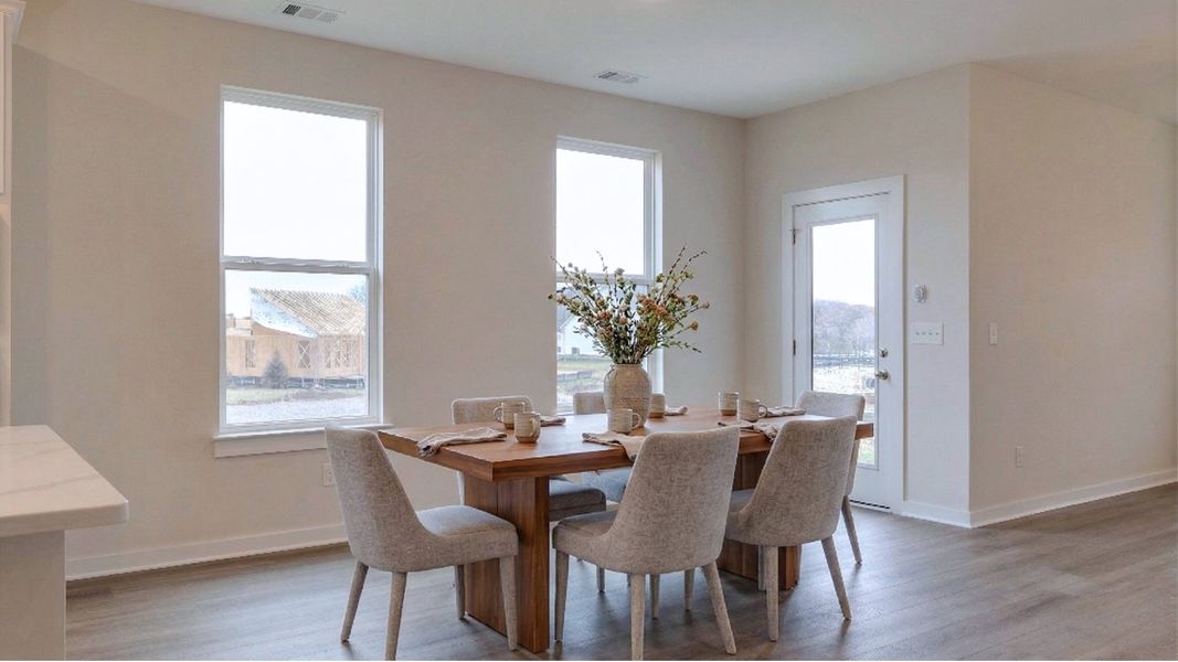 Dining Area located off of the kitchen with natural light from nearby windows and door to outdoor patio