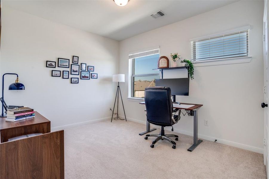 Bedroom with light carpet and baseboards