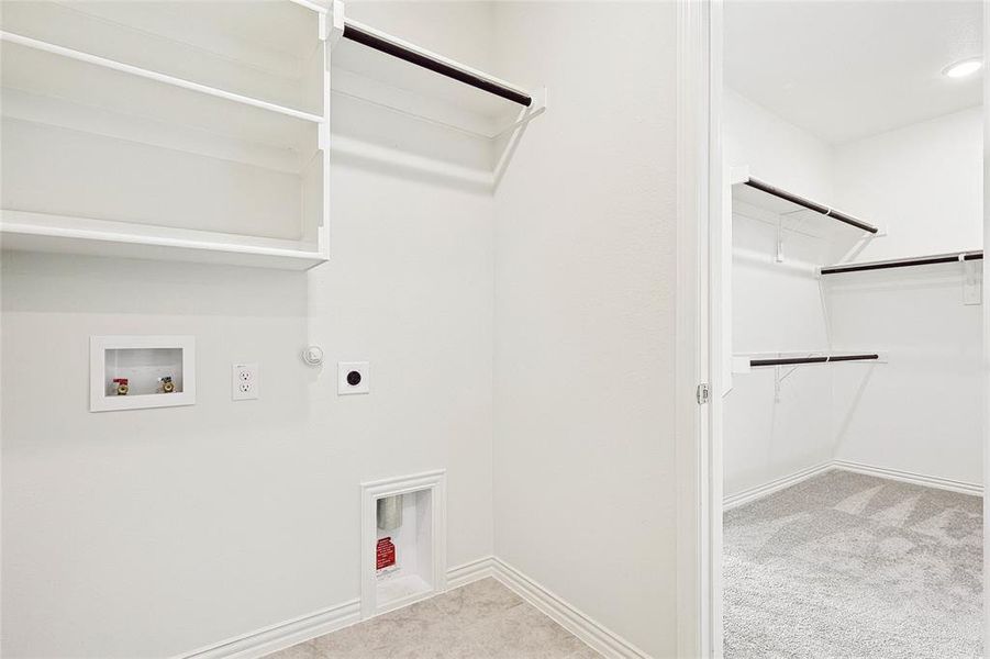 Laundry area featuring hookup for an electric dryer, hookup for a gas dryer, hookup for a washing machine, and light colored carpet