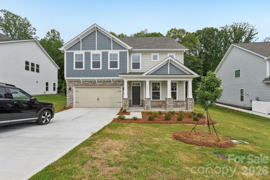 Front exterior of a new home in Falls Cove, Troutman, NC, highlighting curb appeal (Image 2). Front exterior of a new home in Falls Cove, Troutman, NC, highlighting curb appeal (Image 2).