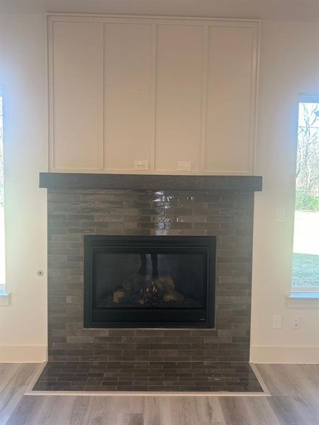 Close-up view of gas fireplace with outlet above mantel