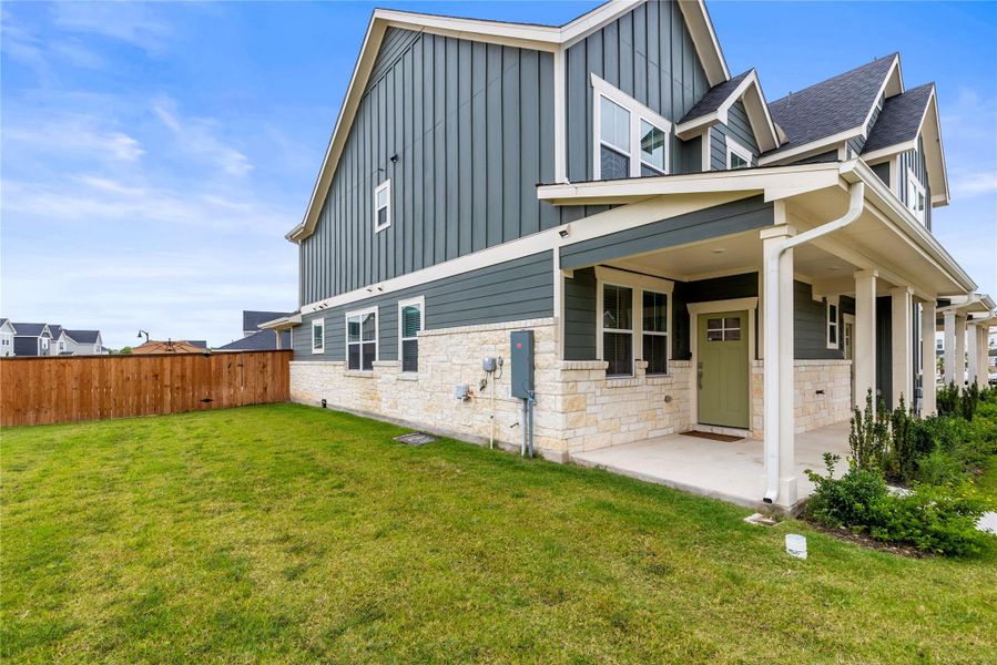 A well-maintained side yard with a charming patio area invites outdoor enjoyment and privacy.