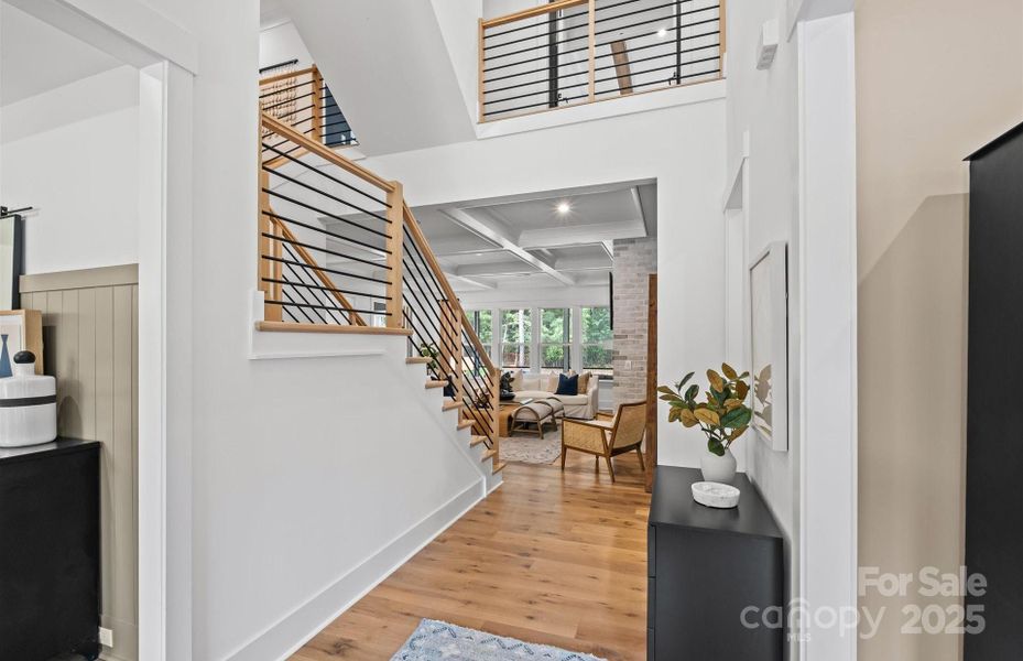 Open Foyer.  Staircase features dramatic horizontal railing.  Representative photo.