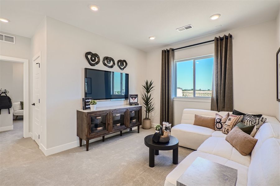 A living room with a tv and couches. A living room with a tv and couches.