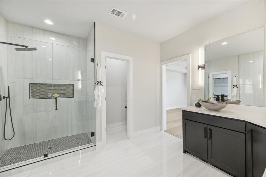 Bathroom with vanity, an enclosed shower, and tile patterned floors