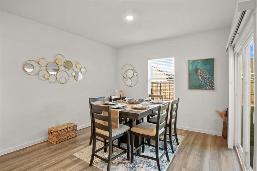 Dining space featuring light wood finished floors and baseboards