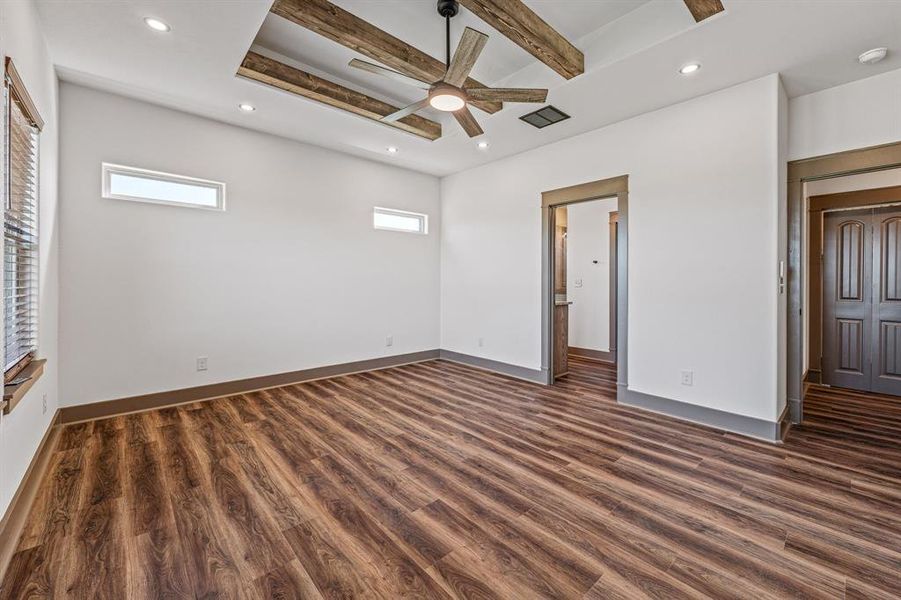 Unfurnished bedroom featuring beam ceiling, dark wood finished floors, recessed lighting, ceiling fan, and connected bathroom