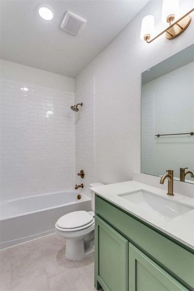Full bath featuring vanity, tub / shower combination, and tile patterned flooring Full bath featuring vanity, tub / shower combination, and tile patterned flooring