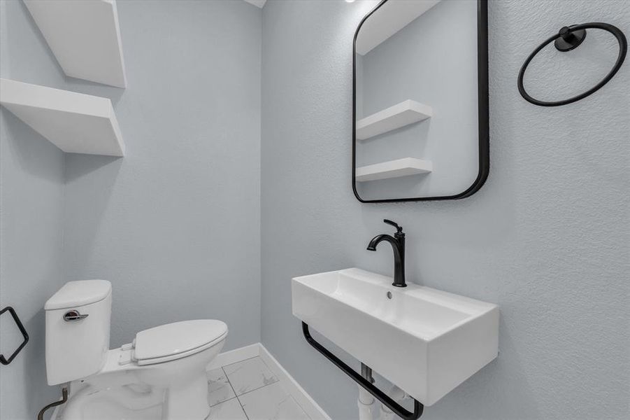 Bathroom with light marble finish floors and baseboards Bathroom with light marble finish floors and baseboards