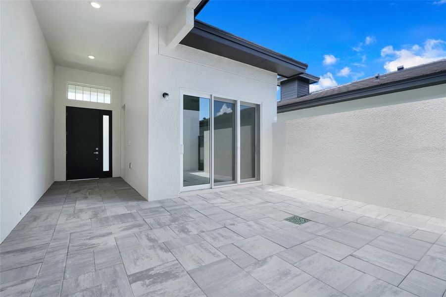 Exterior details and patio area of a home in Hampton Green at Providence, Davenport (Image 4).