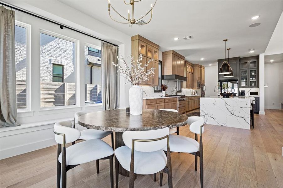 Dining space with light wood-type flooring, healthy amount of natural light, a chandelier, and recessed lighting Dining space with light wood-type flooring, healthy amount of natural light, a chandelier, and recessed lighting