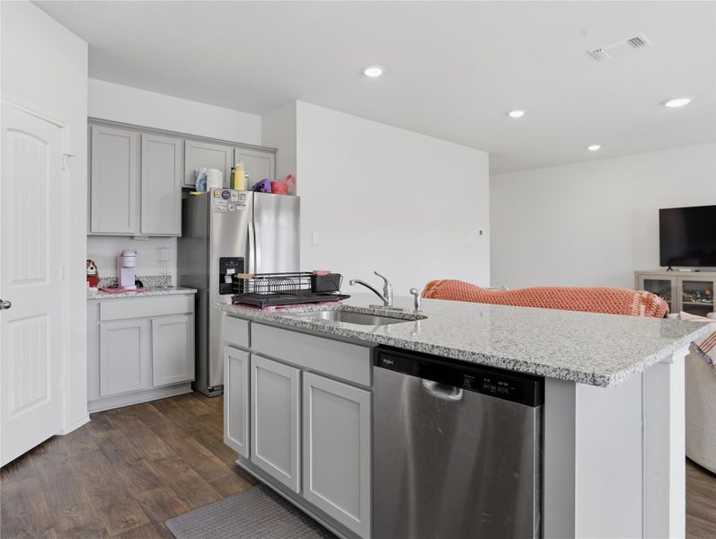Polished stone countertops and seamless flooring define this inviting culinary workspace. Polished stone countertops and seamless flooring define this inviting culinary workspace.