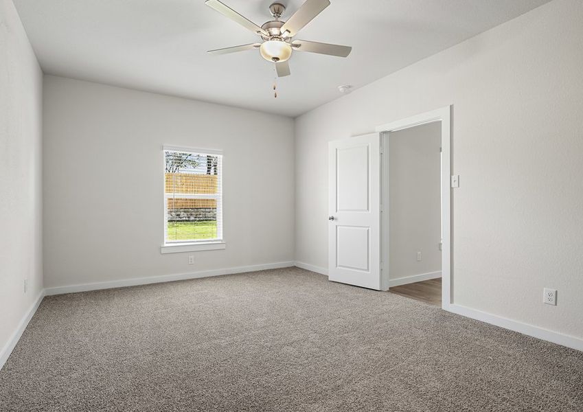 The spacious master bedroom has a window that lets in great, natural light and backyard views.