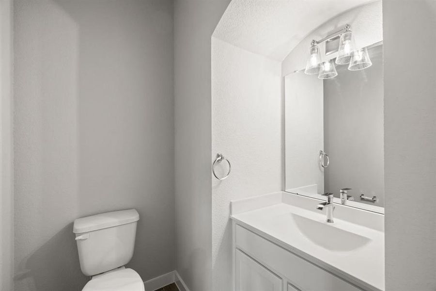 This half bathroom features a stylish pedestal sink, modern hardware, and bright recessed lighting, creating a sleek and inviting space. Sample photo, actual color and selections may vary.