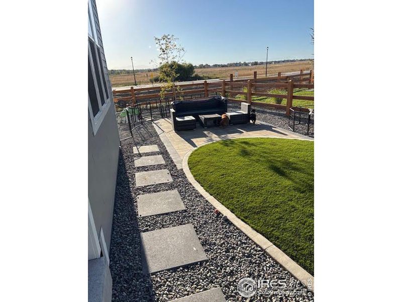 Summertime photo showing fabulous finished backyard landscaping. Views of the mountains on a clear day