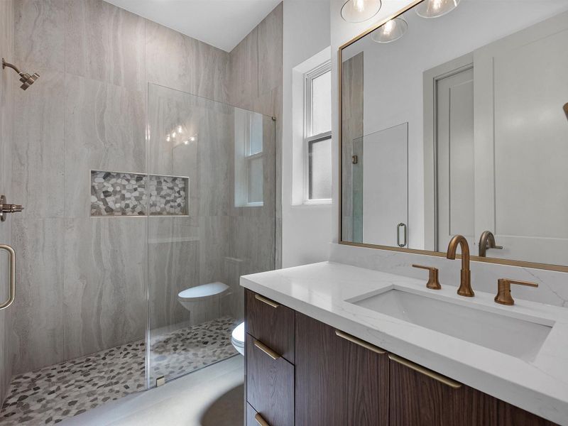 En-suite bathroom for secondary bedroom 3 with a built in closet.