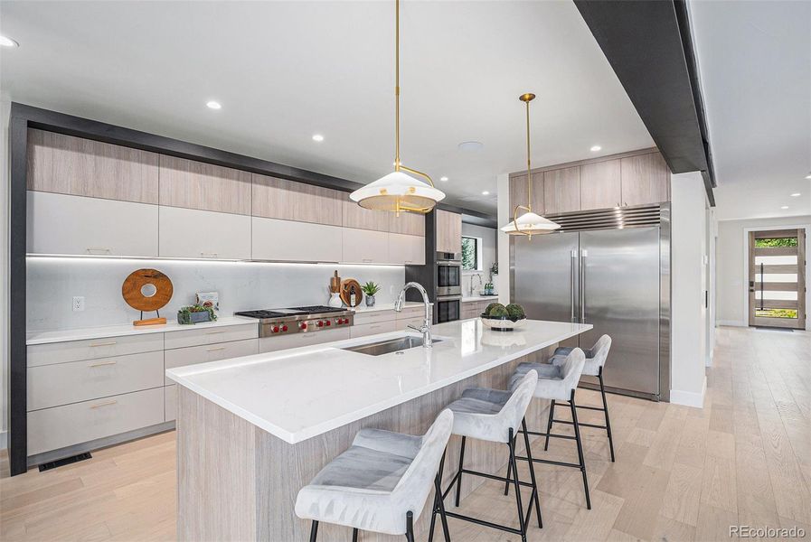 Gorgeous kitchen with quartz counters & 65-inch Electrolux fridge