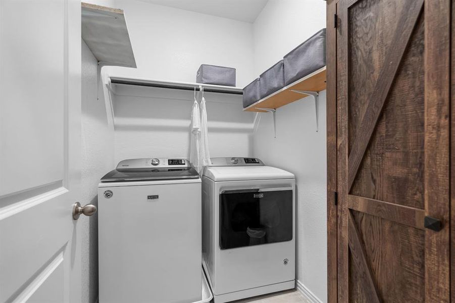 Functional laundry room with a barn door