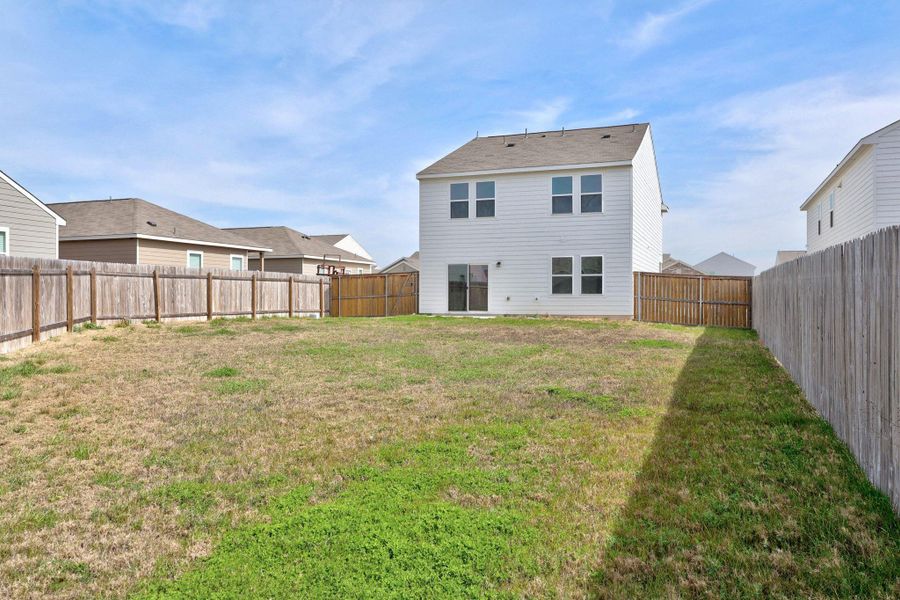 Back of property featuring a fenced backyard