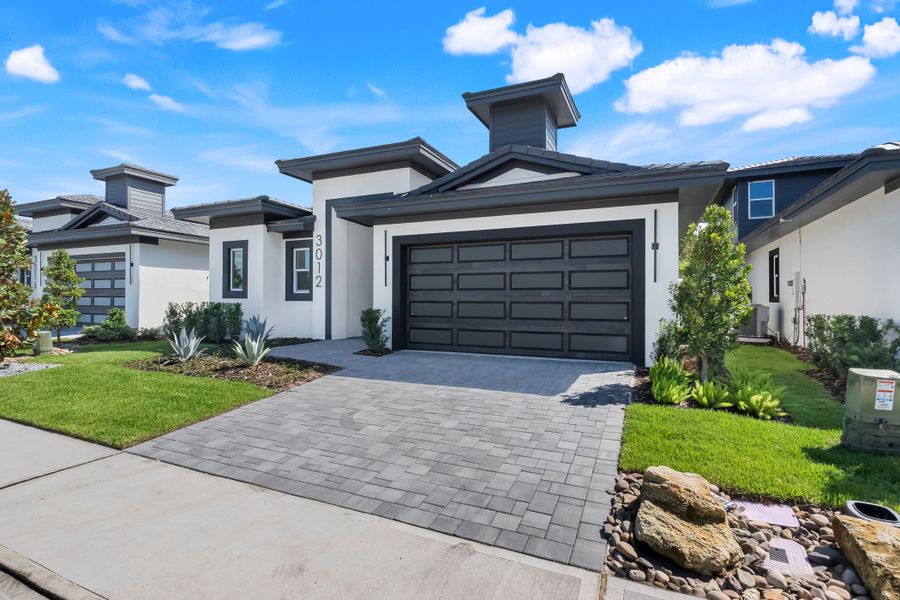 Front exterior of a new home in Hampton Green at Providence, Davenport, FL, highlighting curb appeal (Image 25). Front exterior of a new home in Hampton Green at Providence, Davenport, FL, highlighting curb appeal (Image 25).