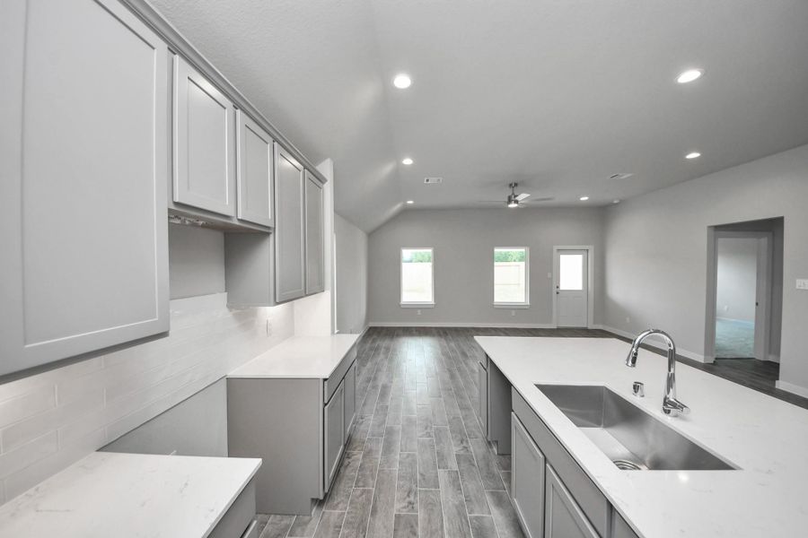 All of this overlooks your expansive family room, creating a perfect space for culinary delights and family gatherings. Sample photo of completed home with similar floor plan. Actual colors and selections may vary. All of this overlooks your expansive family room, creating a perfect space for culinary delights and family gatherings. Sample photo of completed home with similar floor plan. Actual colors and selections may vary.