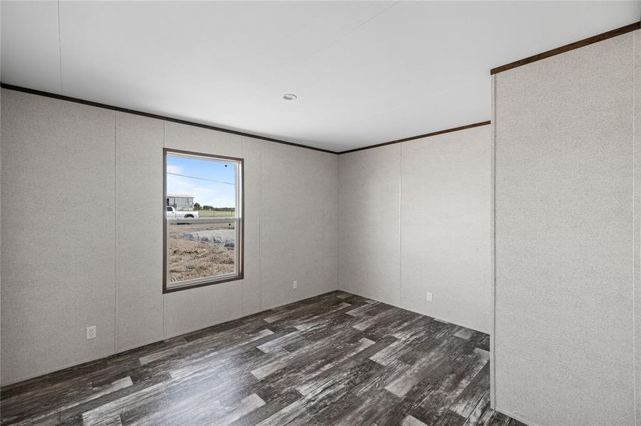 Empty room featuring dark hardwood / wood-style flooring