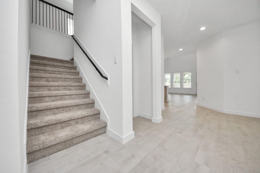 Come upstairs and enjoy a day of leisure in this fabulous game room! This is the perfect hangout spot or adult game room! Features plush carpet, high ceilings, custom paint and windows for plenty of natural light. Sample photo of completed home with similar floor plan. Actual colors and selections may vary.
